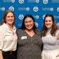 Three alums smiling for a photo.